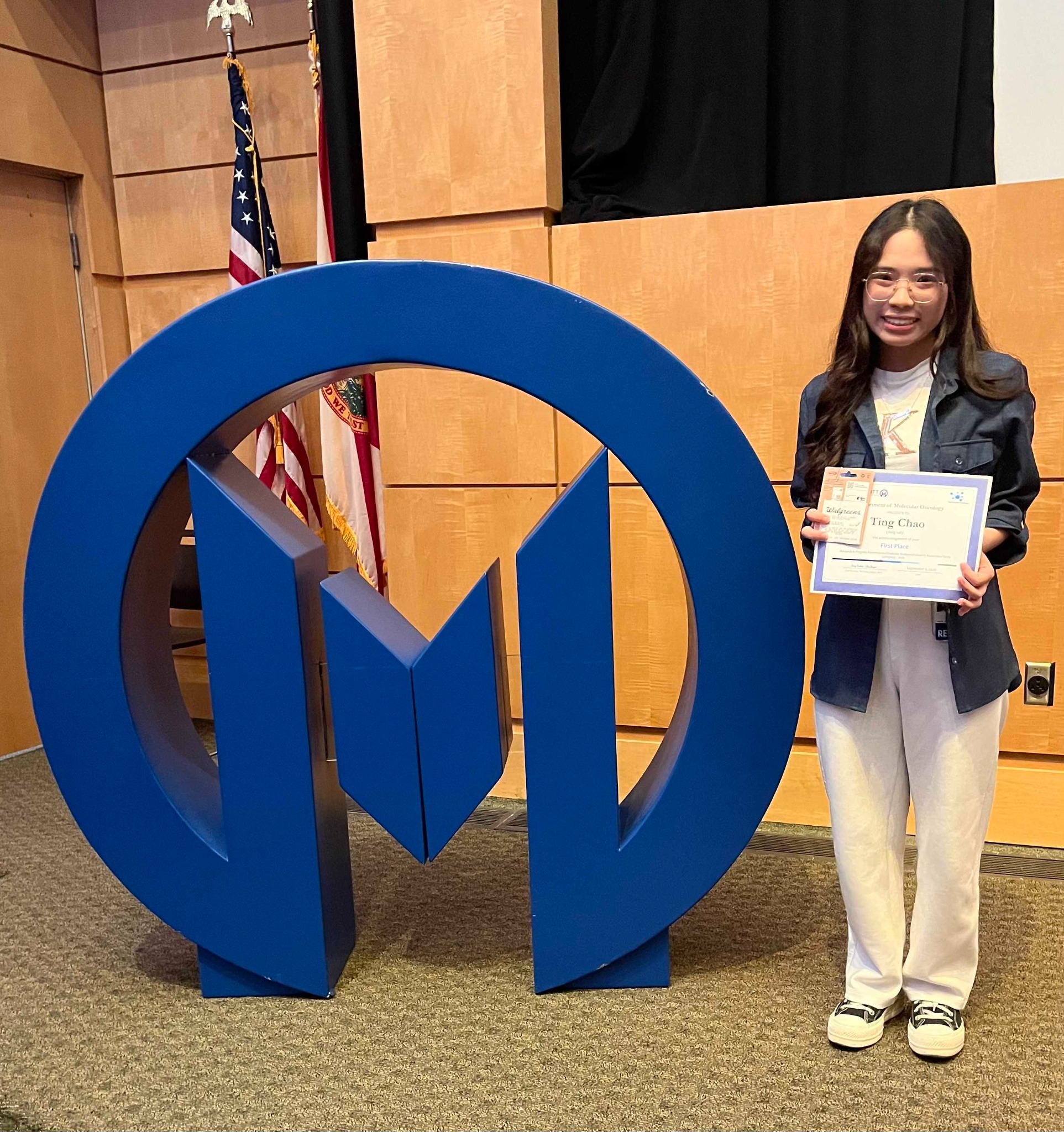 Ting holding her first-place Junior Trainee Award at the Molecular Oncology RIP seminar